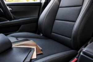 Banco automotivo em laminado sintético de PVC, com amostras de revestimento, destacando opções da Agro Química São Gabriel para acabamento e durabilidade.